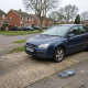 Non-running car on a driveway with recovery equipment ready for collection